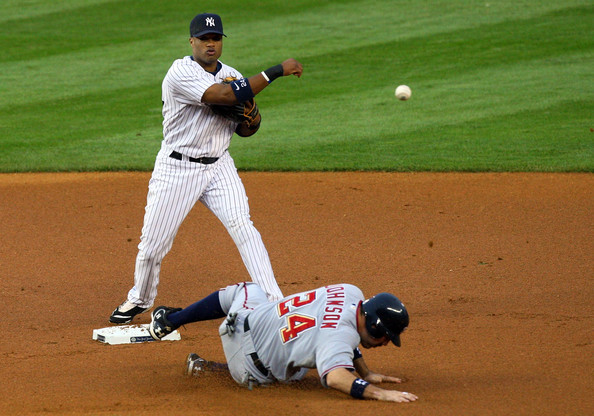 Robinson Cano Robinson Cano #24 of the New York Yankees throws to first base to complete a double play after forcing out Nick Johnson #24 of the Washington Nationals on June 17, 2009 at Yankee Stadium in the Bronx borough of New York City.